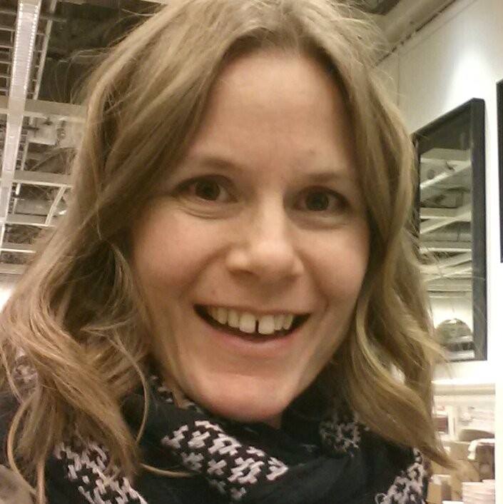 Sarah Tudway-Cains smiling because she is excited to help you bring more calm and peace to your life with her decluttering and organizing services. 